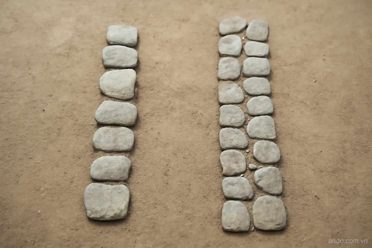 Two stone paths of different lengths drawn side by side on flat ground, plain overhead view, no text