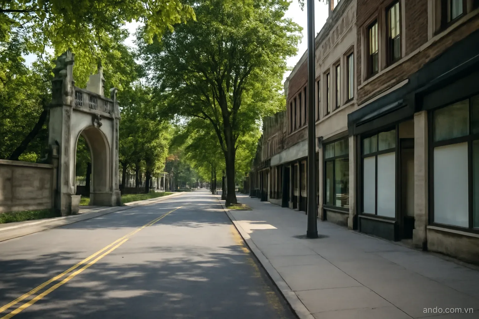 A city street with a university gate on one side and small shops opposite, eye level, no text